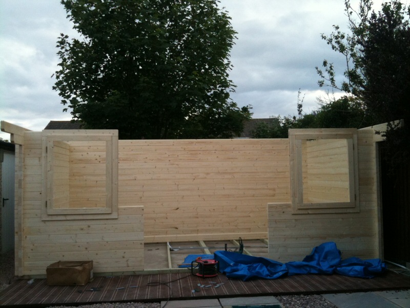 Photo - Outside Office (4 of 7) - A few hours in and the log cabin is taking shape with window frames fitted - Log Cabins - Home - © J C Joinery