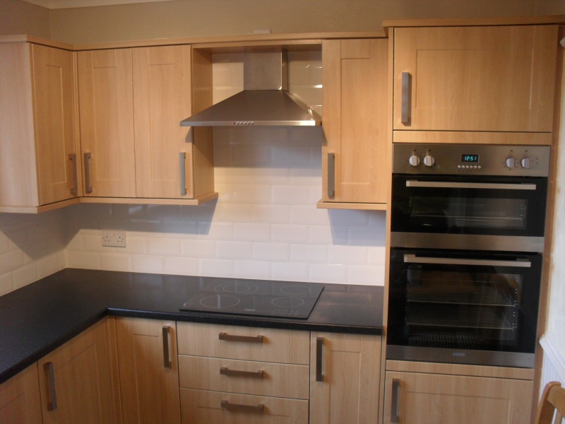 Photo - Solid Oak Kitchen (1 of 2) - Solid oak fitted kitchen with integrated cooker, grill and hob for customer in Fleetwood. - Fitted Kitchens and Bathrooms - Home - © J C Joinery